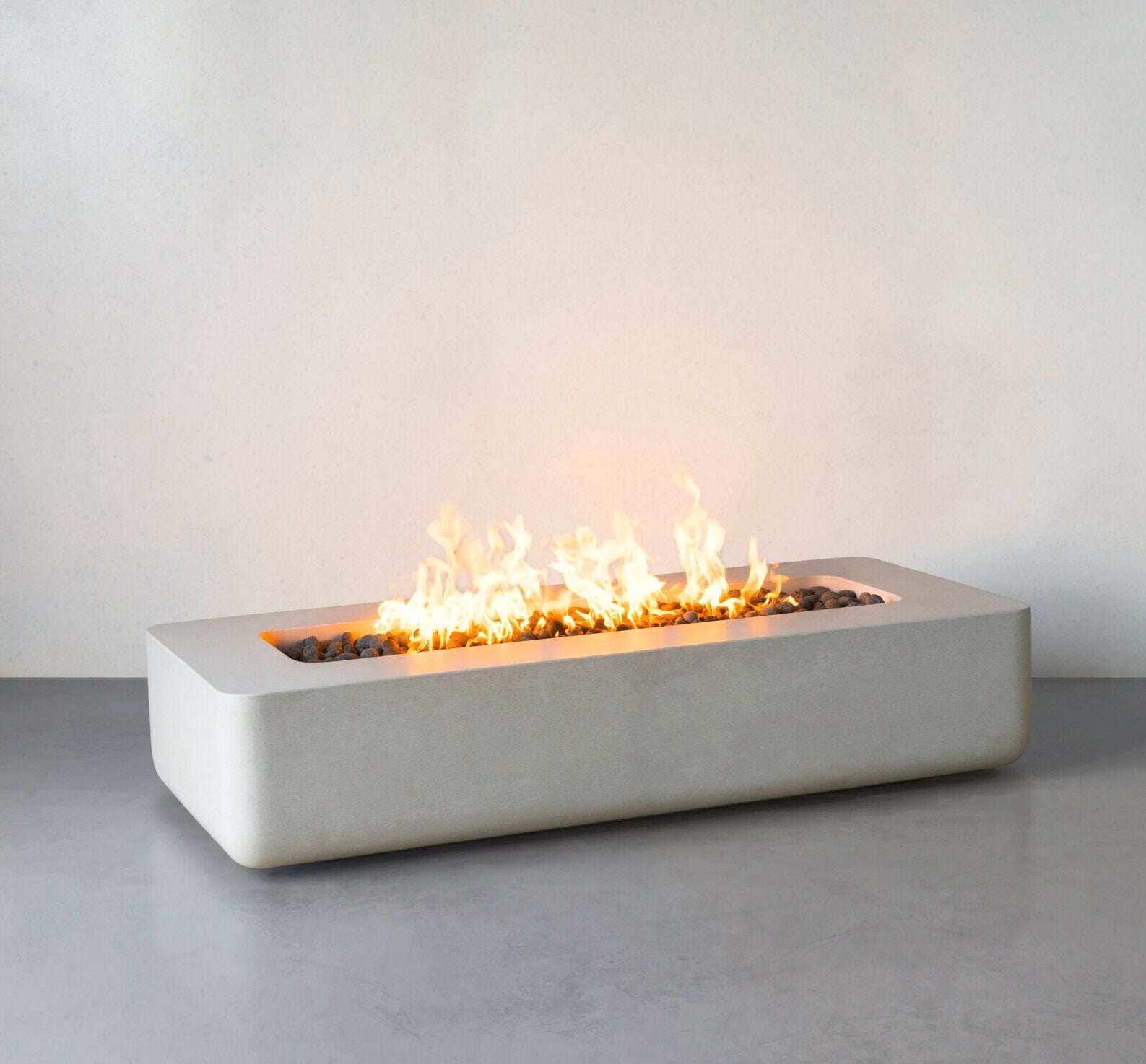 Lumera rounded corners fire pit in light gray color - lifestyle shot