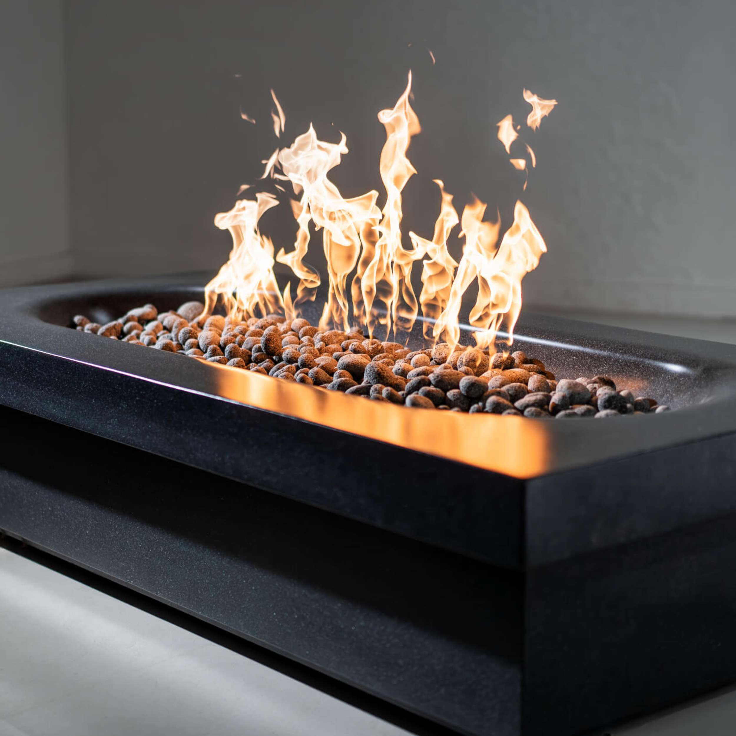 Fortis fire pit by wetstone design - black color rectangular with gas flames lit-close up shot