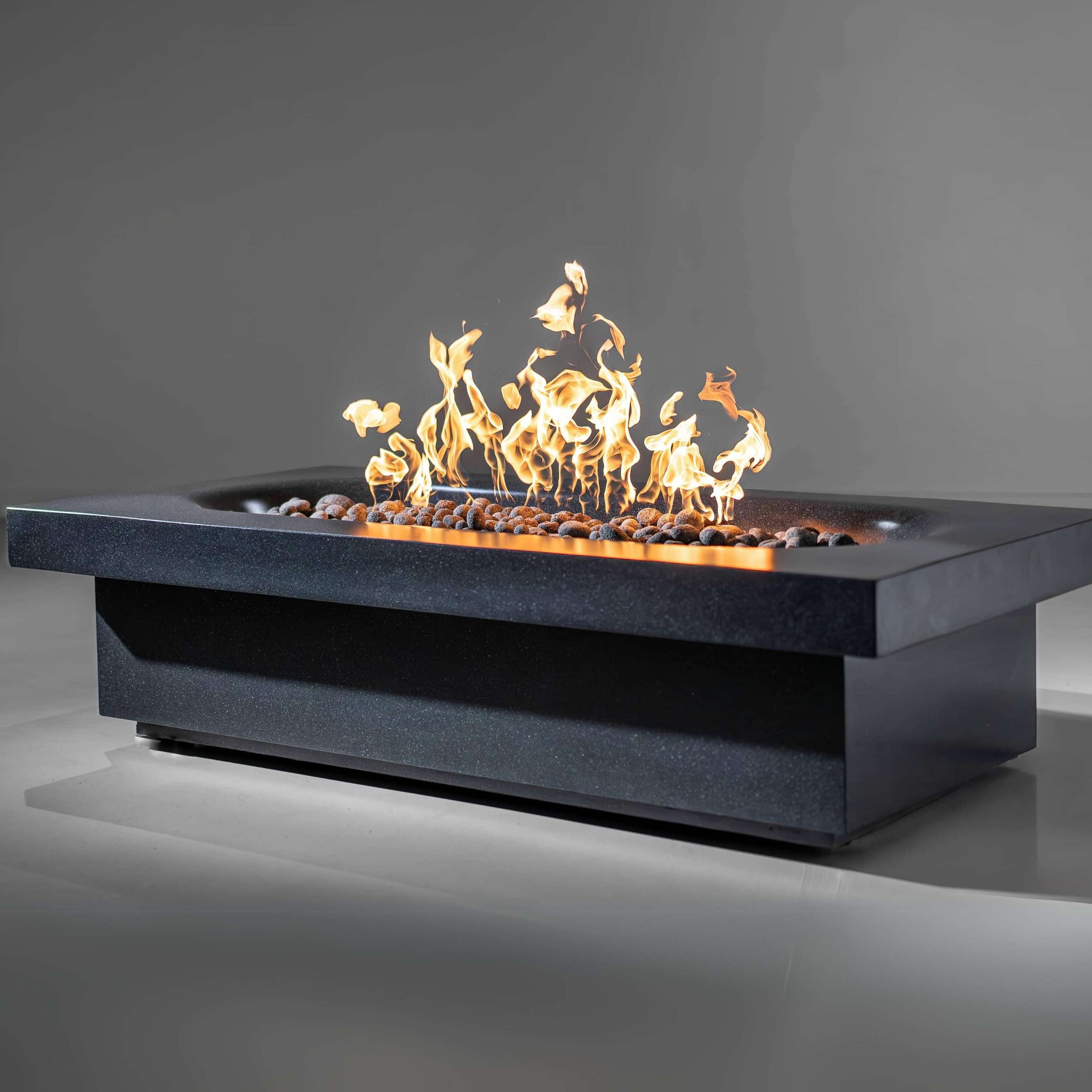 Fortis fire pit by wetstone design - black color rectangular with gas flames lit- angle view