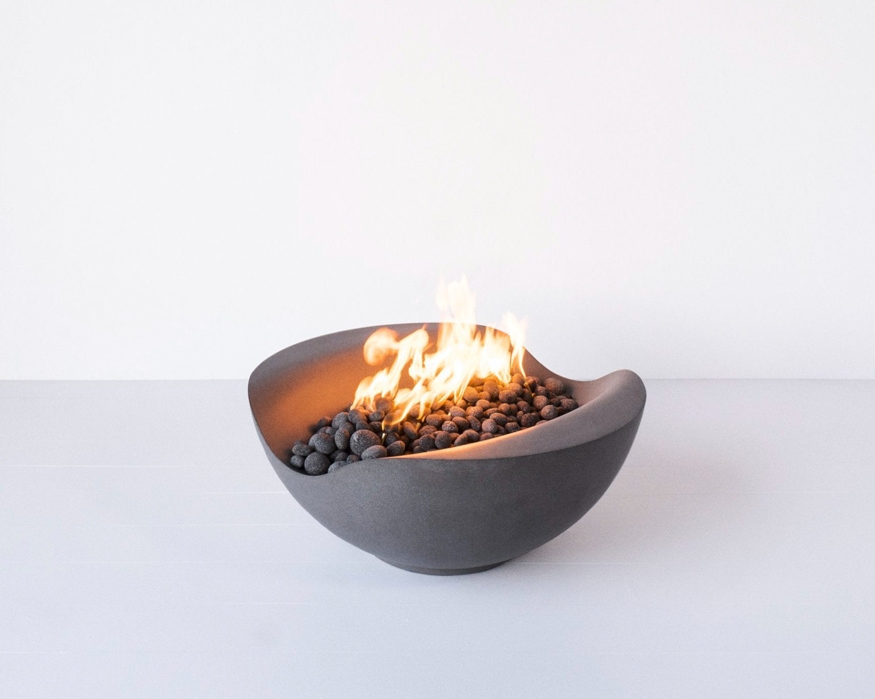 Balance - a round concrete custom made fire pit in dark gray color