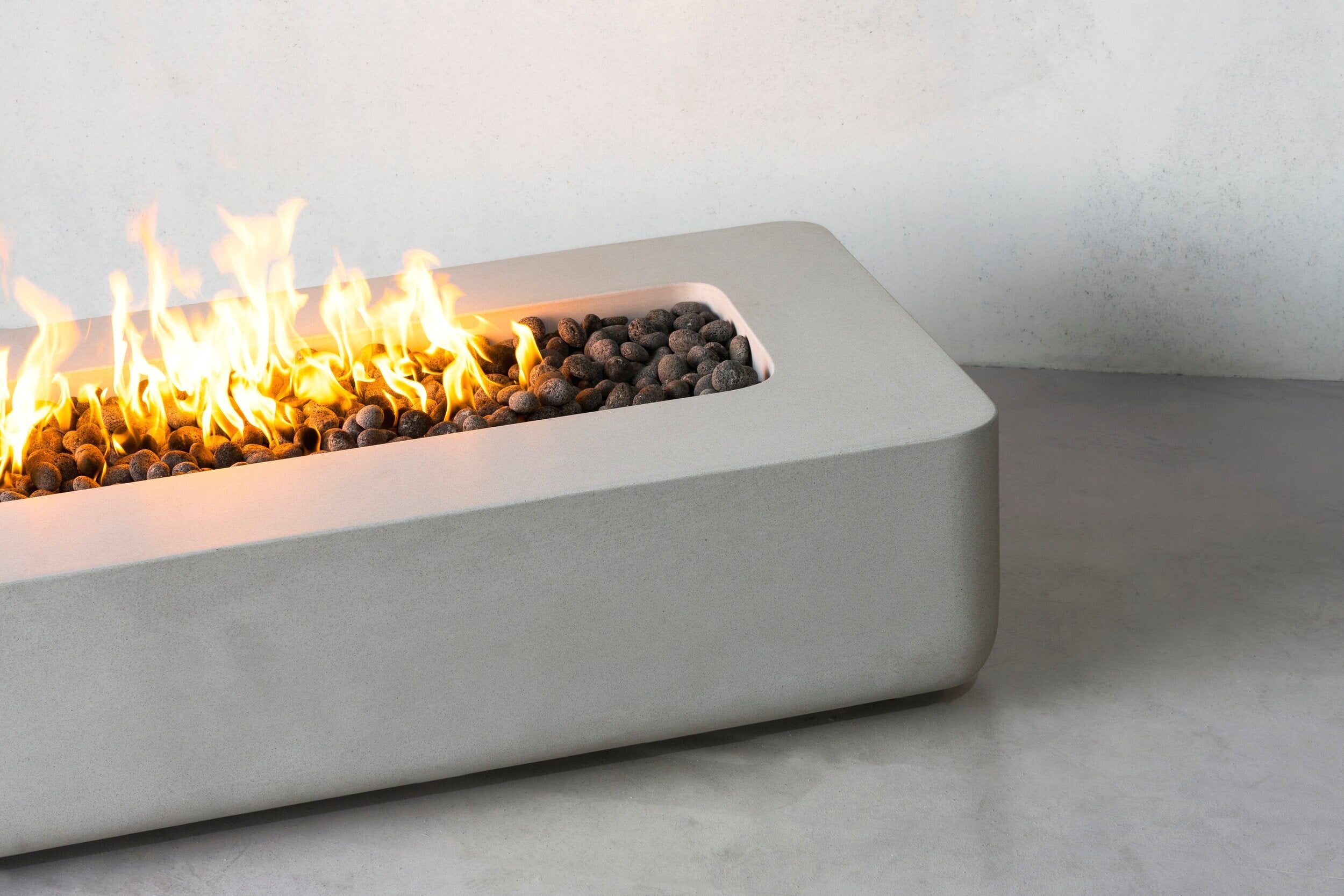 Closeup of Lumera rounded corners fire pit in light gray color - lifestyle shot